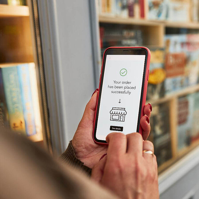 Woman orders a product online via her smartphone